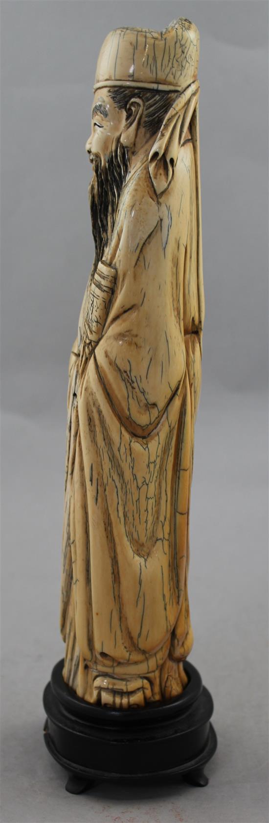 A Chinese mammoth ivory carving of an immortal, in Ming style, 20th century, 30cm, wood stand